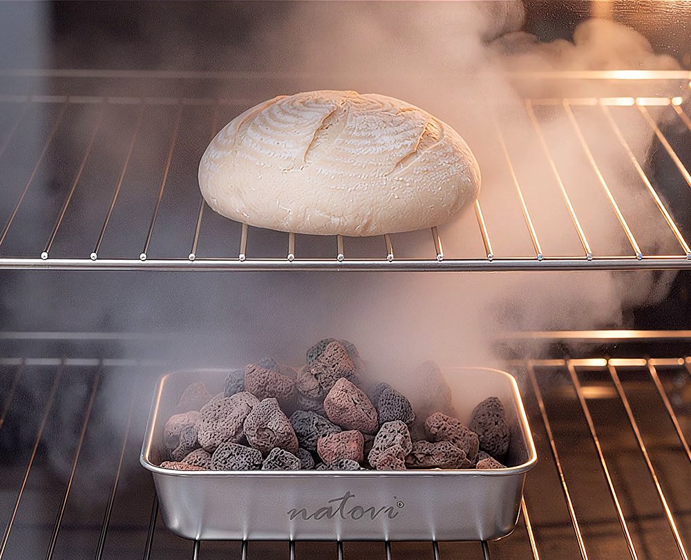 Steam bowl with lava stones in the oven, a loaf of bread in the steam above